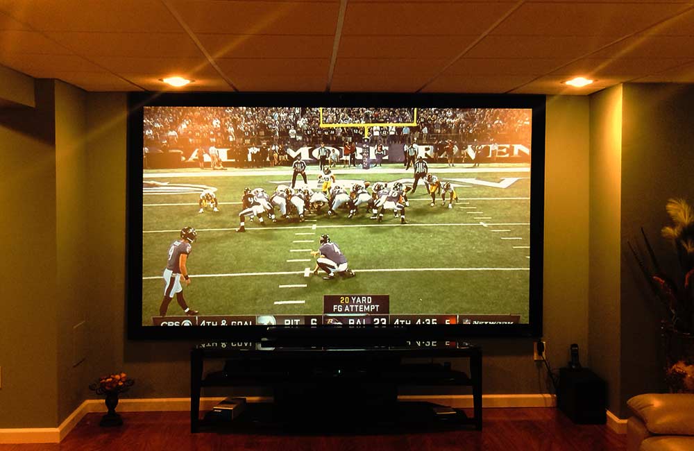 watching football with a projector on a big screen